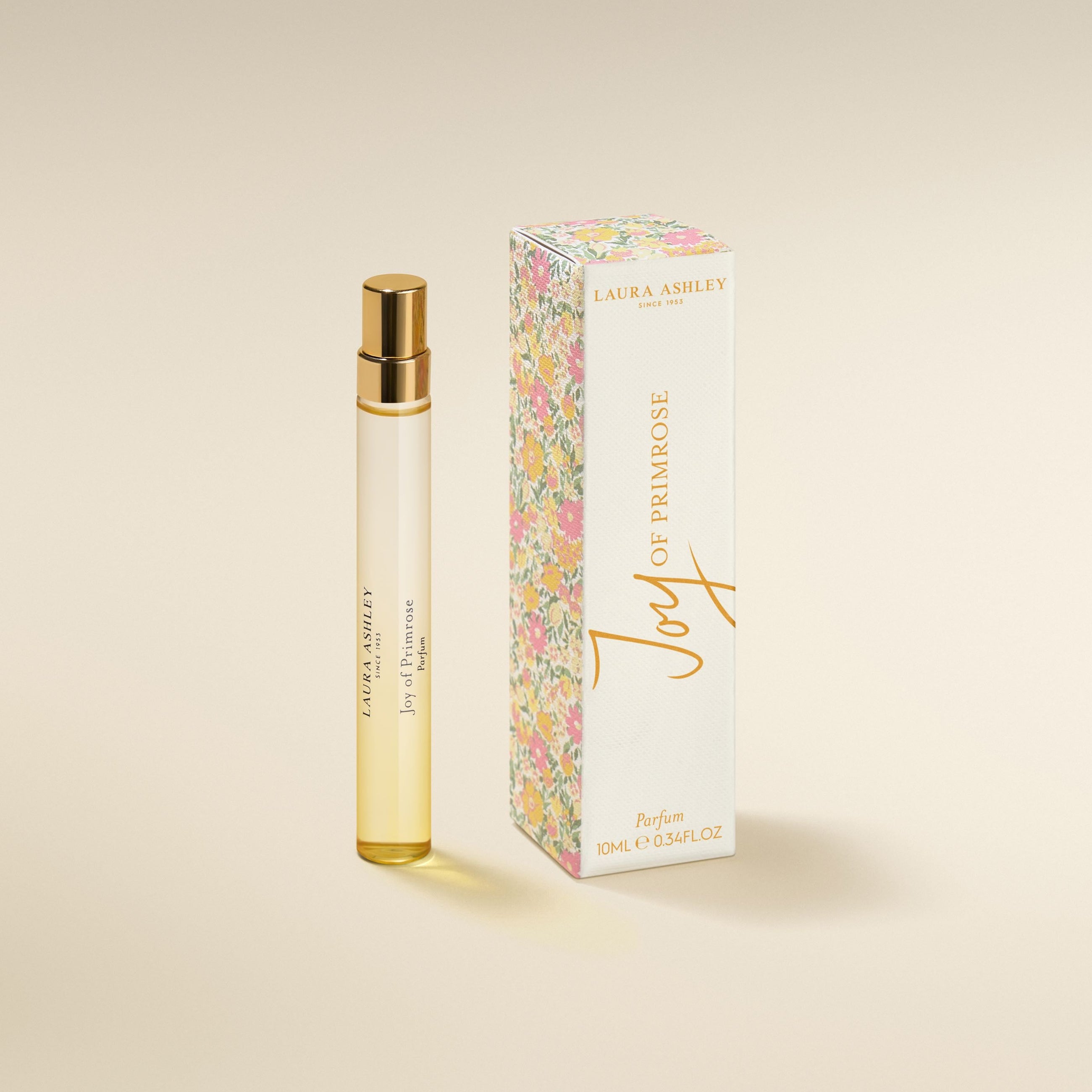 Laura Ashley 'oy of Primrose perfume bottle and packaging on a beige background