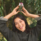 Person holding Wild Woodland against a green leafy background