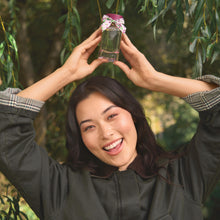 Person holding Wild Woodland against a green leafy background