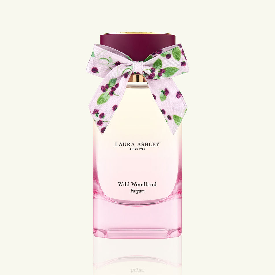 Laura Ashley Wild Woodland perfume bottle with a decorative bow on a white background