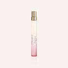 Laura Ashley Floral Fancy Perfume bottle with pink gradient and gold cap on a light beige background