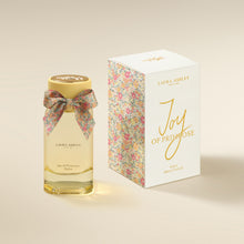 Laura Ashley Joy of Primrose perfume bottle and packaging on a beige background